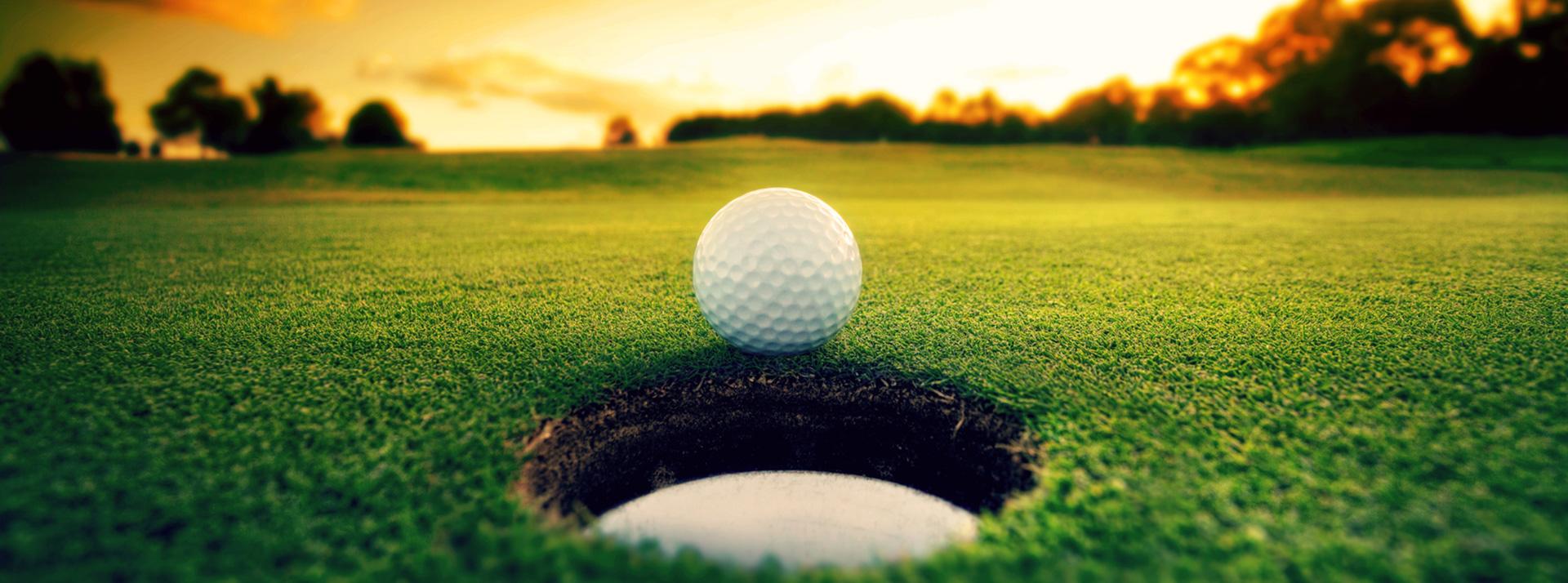 Golf ball in front of golf hole